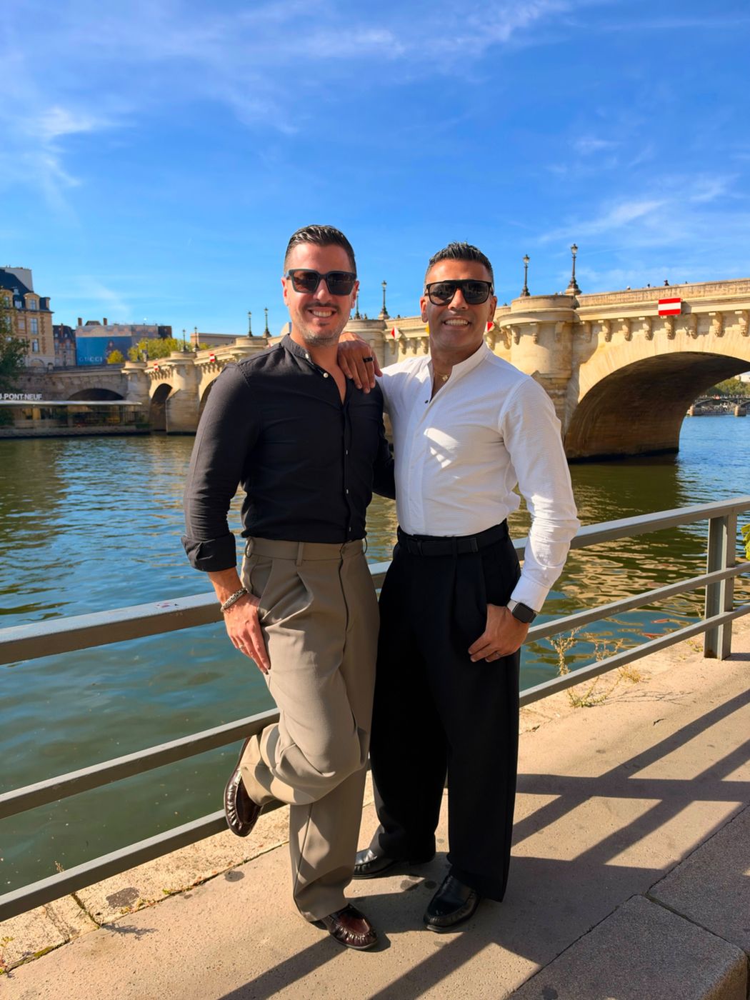 Elie and Justin leaning on a railing along the Seine